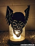 Skull emblem pluggable on candle glass, height 40cm x width 70cm.