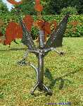 Garden Sculpture dragon from welded and forged sheet steel frontally.